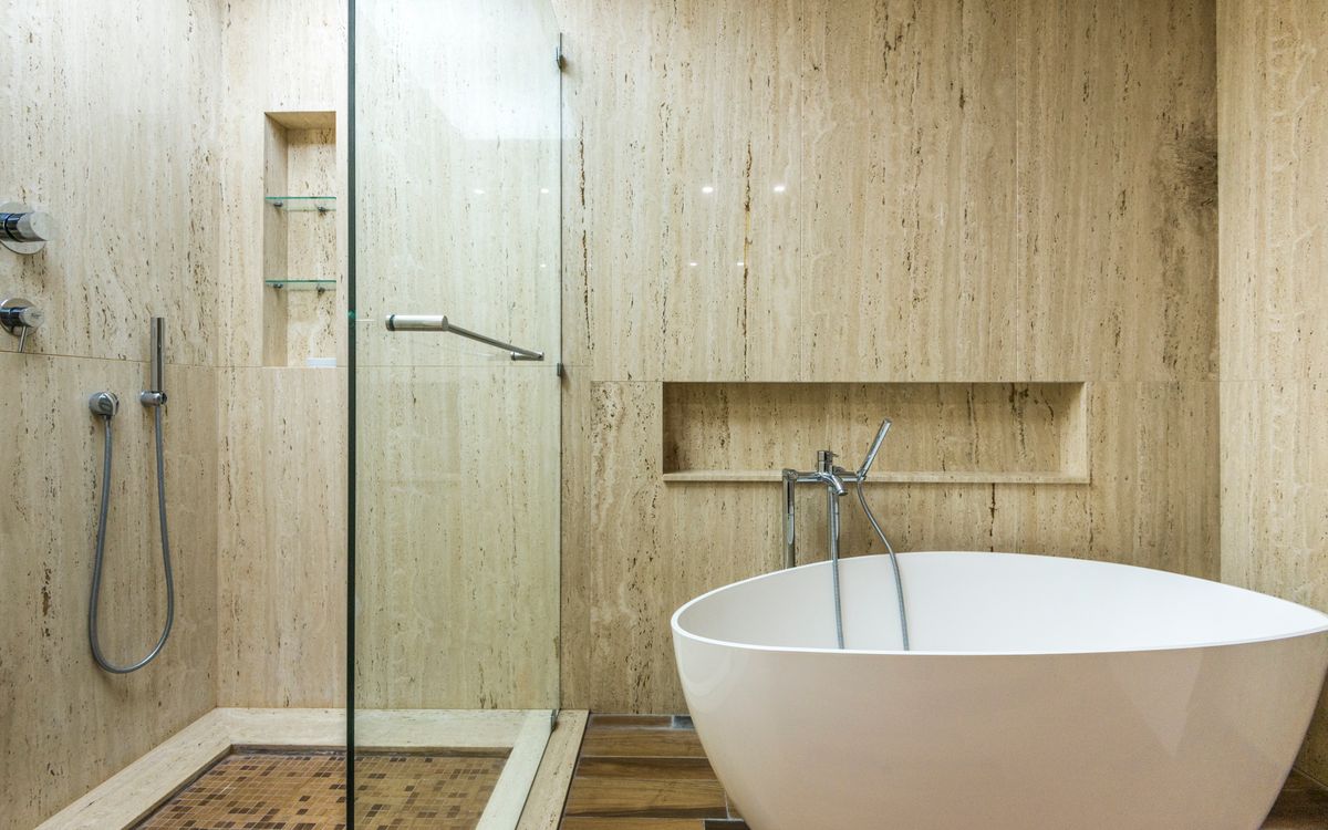 Salle d'eau en travertin toute hauteur avec douche à l'italienne
